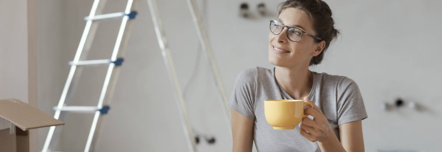 Lady relaxing after installing wireless interconnected smoke alarms