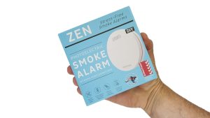 Interconnected smoke alarms - ZEN single box being held by a hand