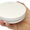 Interconnected smoke alarms - ZEN single smoke alarm being held by a hand (close up)