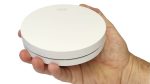 Interconnected smoke alarms - ZEN single smoke alarm being held by a hand (close up)