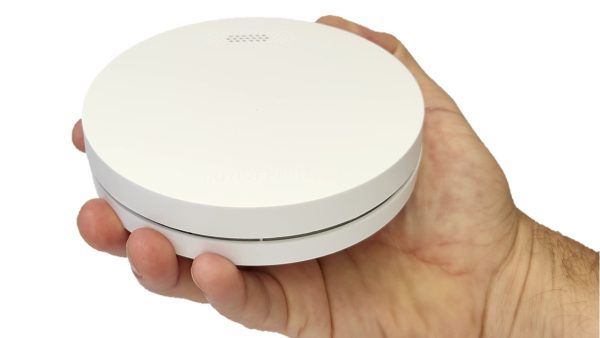 Interconnected smoke alarms - ZEN single smoke alarm being held by a hand (close up)