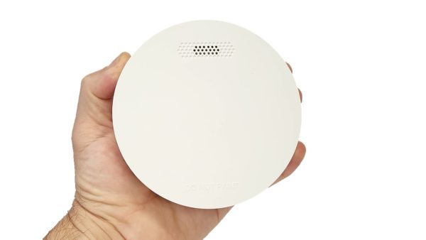 Interconnected smoke alarms - ZEN single smoke alarm being held by a hand