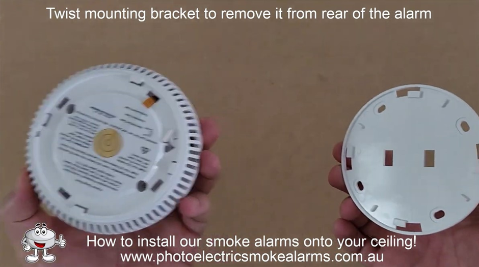 Twist mounting bracket and remove from rear of the smoke alarm