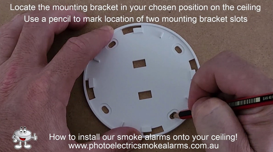use a pencil to mark out the smoke detector mounting bracket slots on the ceiling