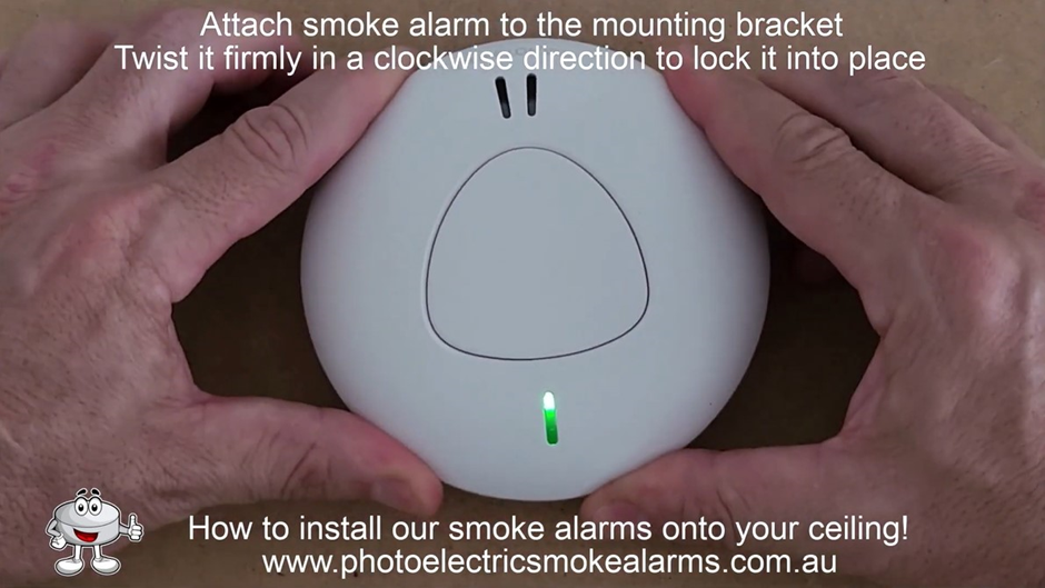 Firmly twist the smoke detector in a clockwise direction to lock it into place on the mounting bracket on the ceiling