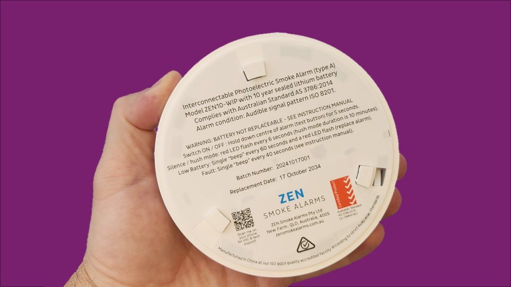 ZEN interconnected smoke alarm image - being held by a hand - QLD compliant