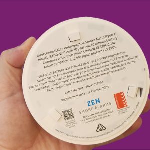 ZEN interconnected smoke alarm image - being held by a hand - QLD compliant