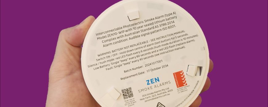 ZEN interconnected smoke alarm image - being held by a hand - QLD compliant
