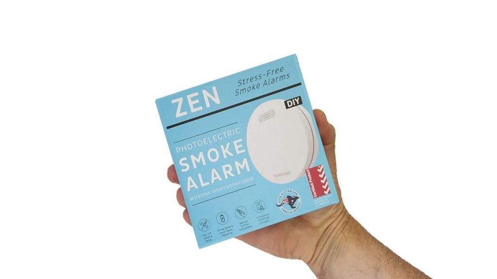 ZEN interconnected smoke alarm 1-pack box being held by hand - close up