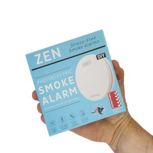 ZEN interconnected smoke alarm 1-pack box being held by hand - close up